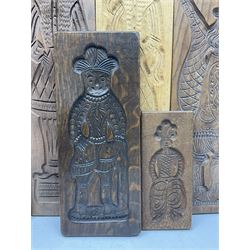 Eight 20th century hardwood Dutch folk art Speculaasplank or biscuit moulds, most examples typically carved with figures in traditional dress, tallest H60cm