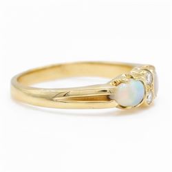18ct gold opal and diamond four stone ring, two round brilliant cut diamonds, with a single cabochon pear cut opal set either side, London 1994