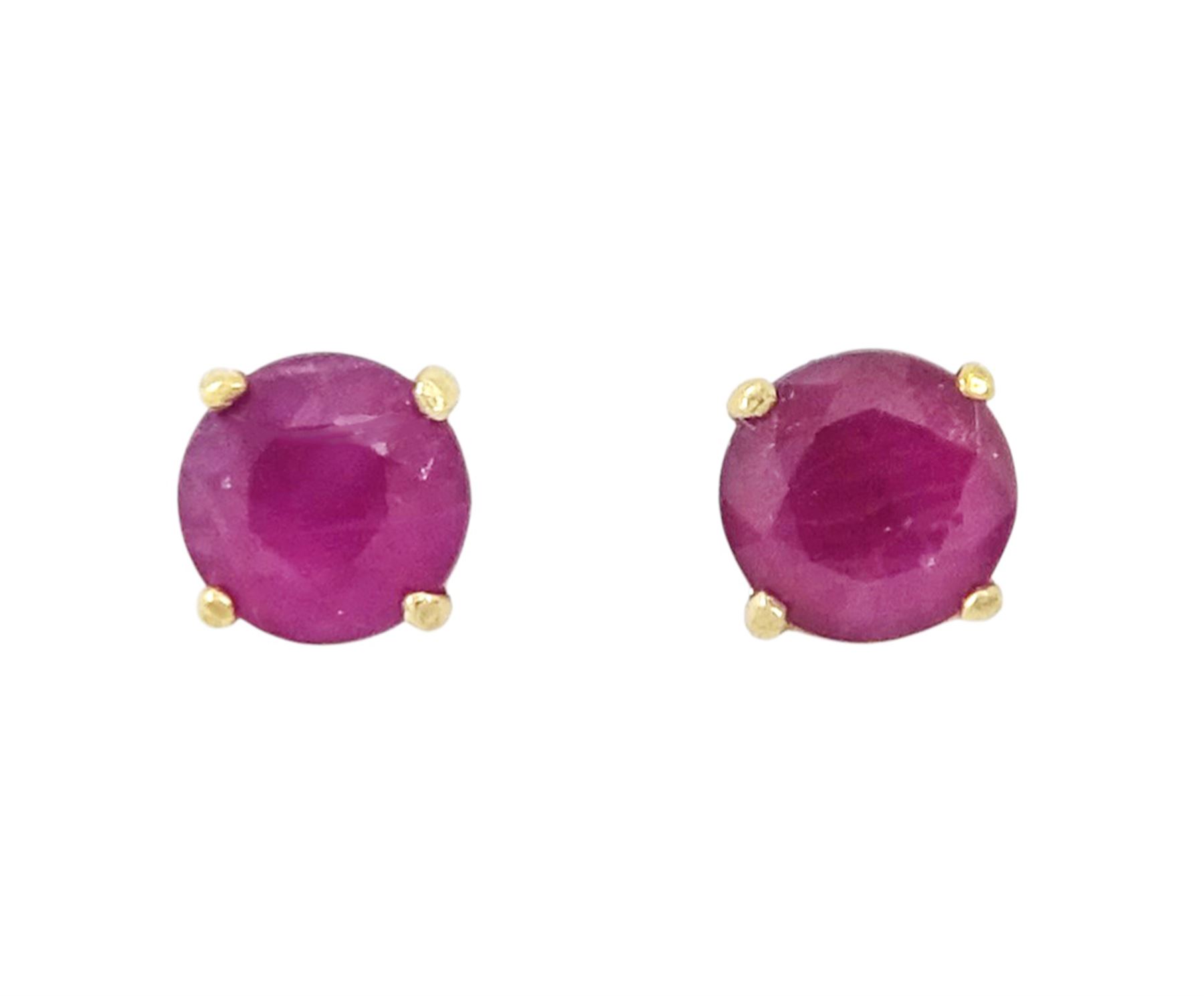 Pair of 9ct gold ruby stud earrings, stamped