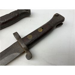 British Pattern 1907 bayonet with 43.5cm fullered steel blade; in leather scabbard with webbing frog L58cm overall; another Pattern 1907 bayonet lacking scabbard; and British Pattern 1888 Mk.I bayonet by Wilkinson London (no scabbard) (3)