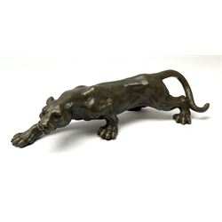 A bronze figure, modelled as a cougar in crouching pose, signed Milo and with foundry mark, L40cm.
