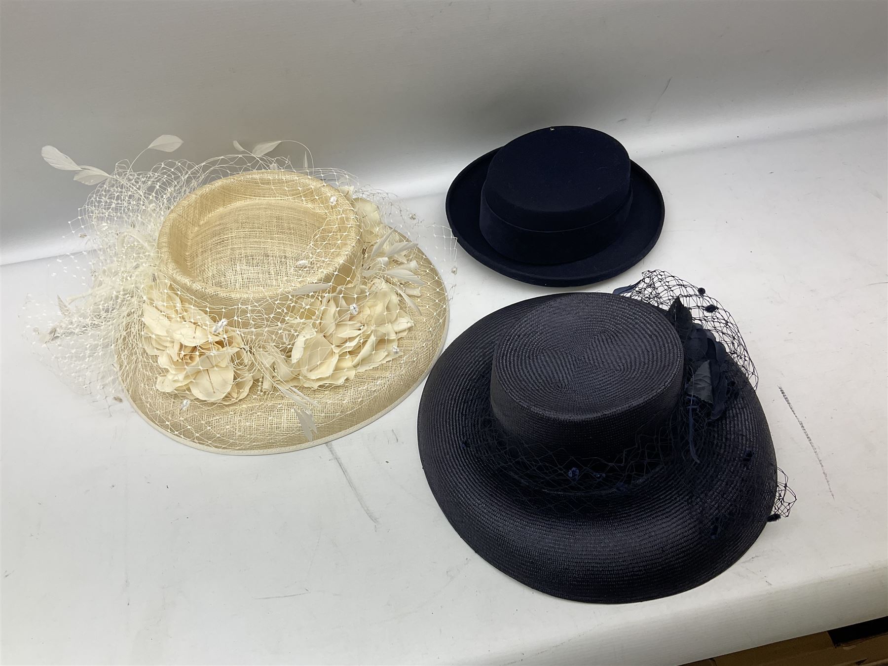 Collection of ladies hats to include boxed Jaeger occasion hat, Frederick Fox of London hat, ribbon band  and feathered decoration examples etc, many with boxes (11)
