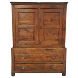 Georgian rustic oak housekeeper’s cupboard, moulded cornice above a pair of fielded panel cupboard doors enclosing a boarded interior with central divider and hanging hooks, the base fitted with two long drawers with brass swan neck handles, raised on stile supports