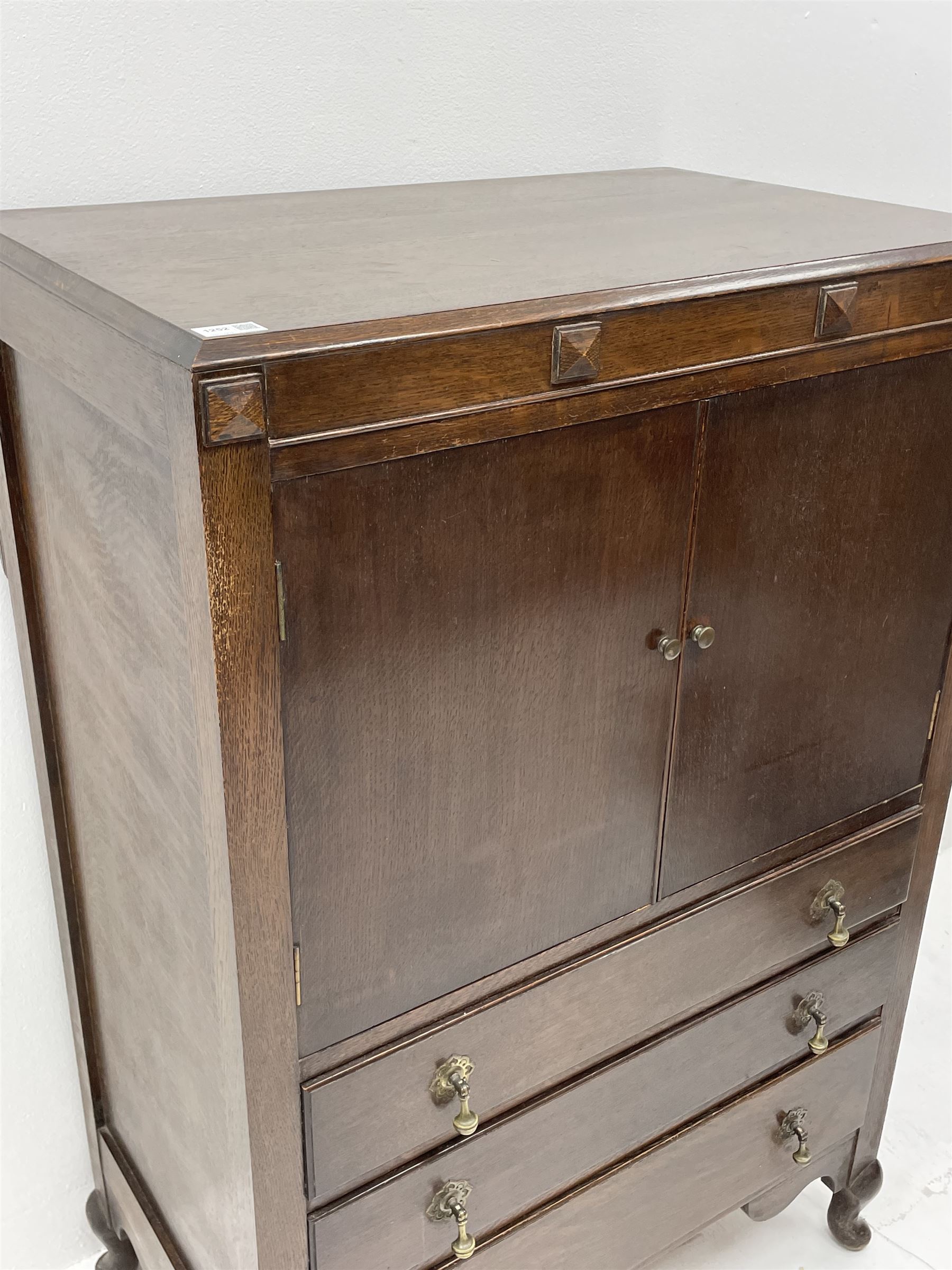 Early 20th century oak tallboy chest, double cupboard doors enclosing interior, above three long graduating drawers, raised on cabriole supports 
