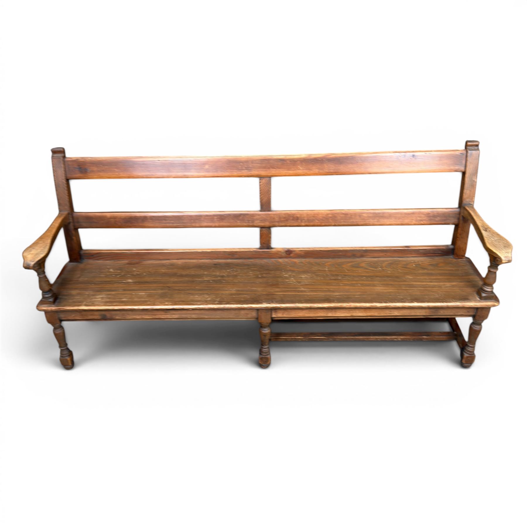 Early 20th century pine and oak bench seat, stained pine rail back frame with shaped oak arms