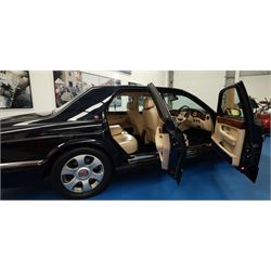 2001 Bentley Arnage Red Label Saloon

Registration: BU51 TGX
Engine: 6.75-litre turbocharged V8 petrol
Transmission: Automatic
Odometer reading: 39,942 miles
Colour: Black Sapphire metallic
Interior: Magnolia leather with burr walnut veneers
Previous owners: 3
V5C: Present
Service history: Good service records

An exceptional Bentley Arnage Red Label Saloon, finished in Black Sapphire metallic, a very dark blue, with a Magnolia leather interior, contrasting dark blue carpets and extensive burr walnut veneers. The car displays an odometer reading of approximately 39,942 miles.

The Arnage Red Label combined Bentley’s renowned 6.75-litre turbocharged V8 engine with automatic transmission, delivering effortless performance in a traditionally appointed luxury saloon. The model is distinguished by its imposing proportions, characteristic Bentley radiator grille and finely crafted interior.

Presented in excellent condition throughout, the bodywork and metallic paint finish appear particularly well preserved, complemented by clean brightwork and the correct Bentley alloy wheels. The engine bay is also notably well detailed.

The interior presents exceptionally well, retaining its Magnolia leather upholstery, polished burr walnut veneers, original factory instrumentation and switchgear. The leather displays only light creasing consistent with careful use.

The car has had three previous owners and is accompanied by good service records.

Features

• 6.75-litre turbocharged V8 petrol engine
• Automatic transmission
• Black Sapphire metallic paintwork
• Magnolia leather interior
• Contrasting dark blue carpets
• Burr walnut veneers
• Electrically adjustable front seats
• Air conditioning
• Factory instrumentation and switchgear
• Bentley alloy wheels
• Right-hand drive
• Odometer reading of approximately 39,942 miles
• Three previous owners
• Good service records
• V5C present

This vehicle forms part of the Estate of the Late John Sills and is offered for sale by the Executors, confirming a genuine reason for sale.