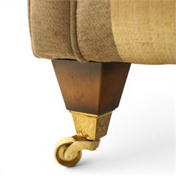 Alstons - 'Ixworth' armchair, upholstered in striped fabric, with loose seat cushions and scrolled arms, brass front castors