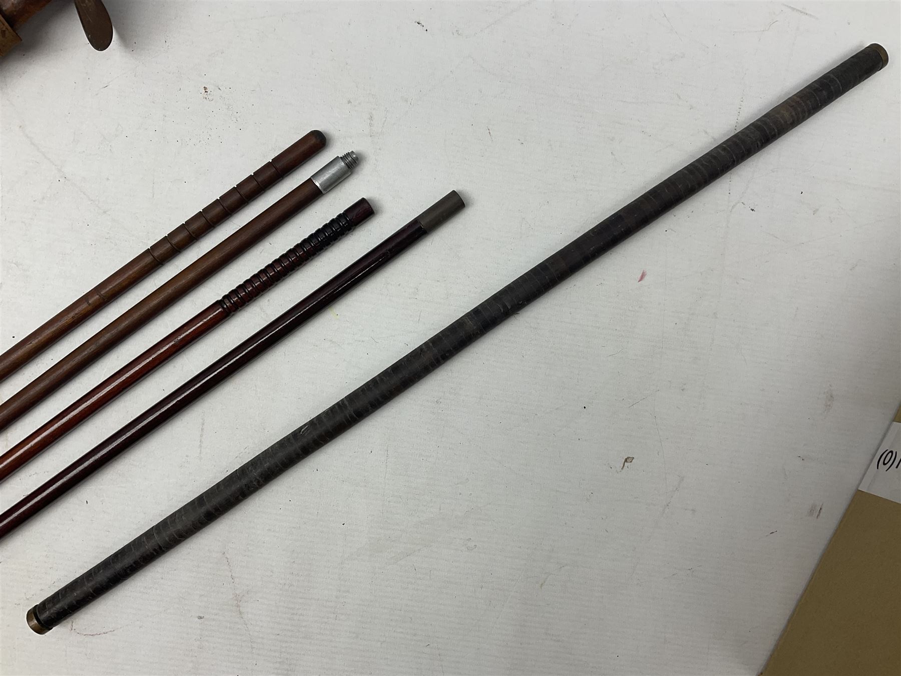 George V 1897 pattern Infantry officers sword, the 82cm single fullered blade with traces of etched detail and George V crown cipher, the ricasso marked Hawksworth Sheffield, pierced half basket hilt with George V cypher, wire-bound fish-skin grip with brass pommel and backstrap; in leather scabbard L102cm overall; together with two sectional gun cleaning rods; swagger stick made of leather strips etc