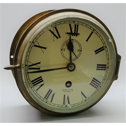  Smiths Astral ship's brass cased bulkhead clock, the white dial with Roman numerals, subsidiary seconds dial and slow/fast facility No 6123 D18cm with key  