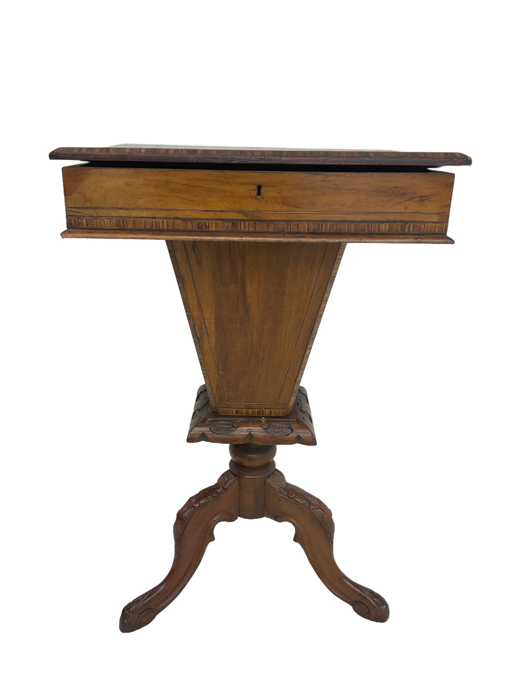 Victorian walnut work table, the rectangular hinged top inlaid with a chessboard design, canted edge with alternating ebony and satinwood inlays, concealing fitted interior, banded and strung frieze over tapering column well, collar carved with foliate decoration, on a cabriole tripod base