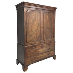 George III mahogany linen press, projecting cornice over two figured doors enclosing five linen slides, the lower section fitted with two short and two long drawers, on bracket feet