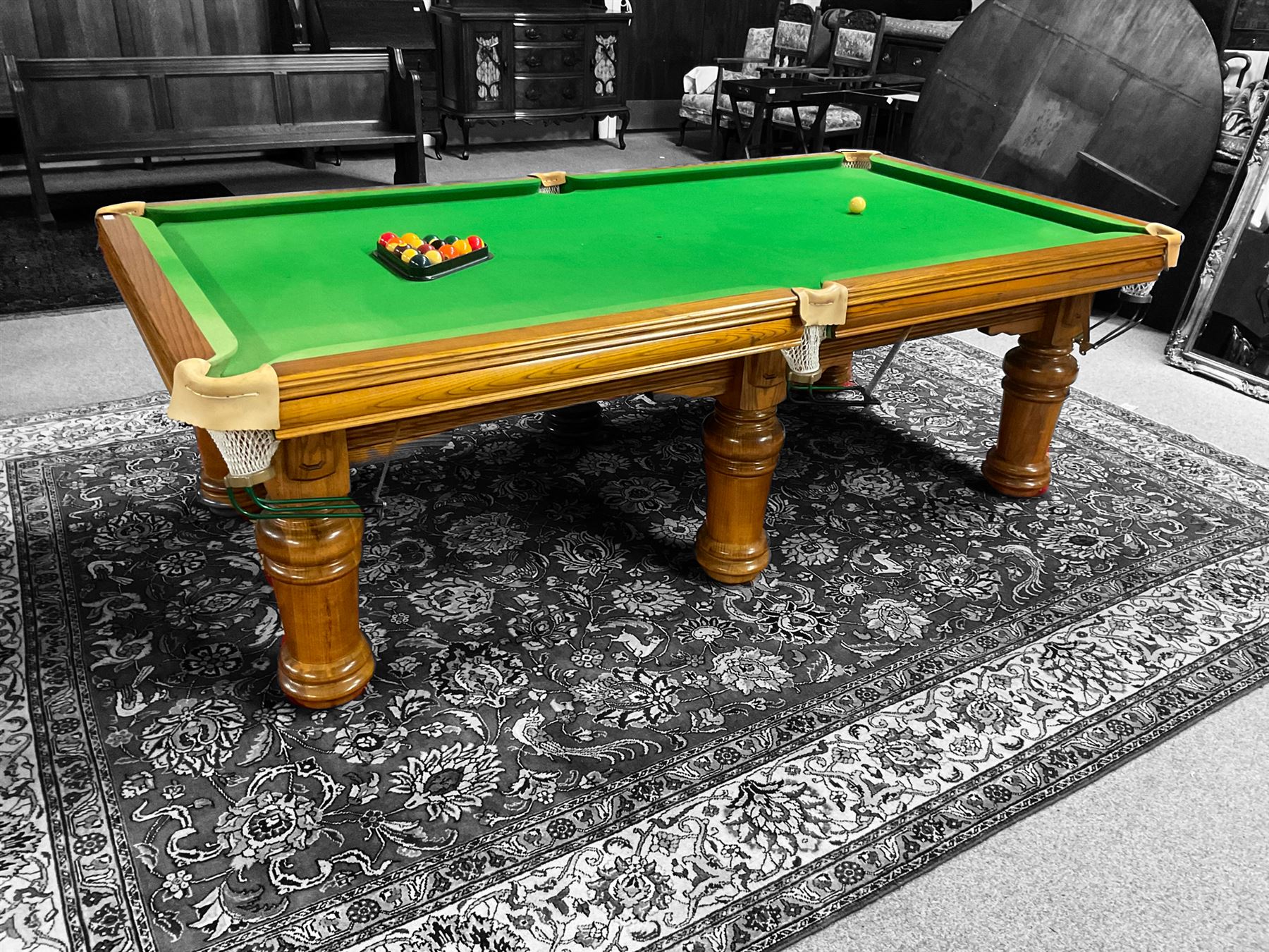 Late 20th century oak slate bed billiard table, on six turned column supports,  together with cues, ball set, baize brush, triangles and scoreboard 