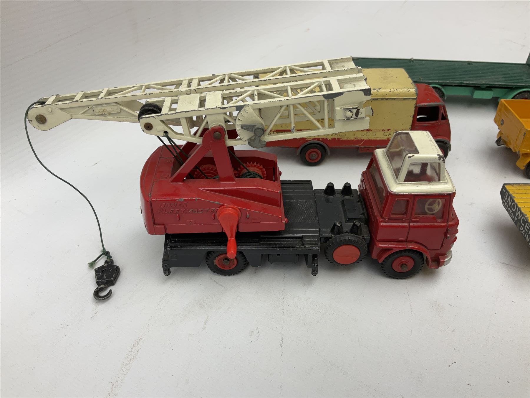 Dinky - eight unboxed and playworn/repainted commercial vehicles including Foden flatbed lorry, Bedford Articulated lorry, Leyland Comet Ferrocrete lorry, Guy Spratts panel van, Fire Engine, Jones Fleetmaster, Commer breakdown truck etc (8)