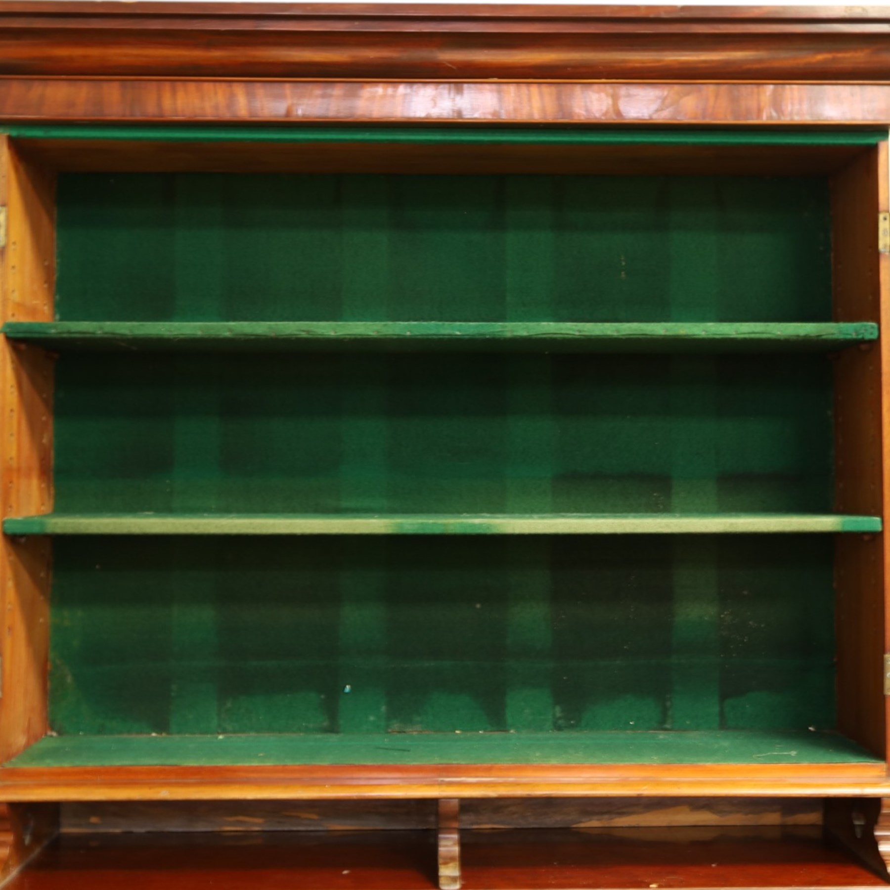 Victorian mahogany cylinder roll-top bookcase-secretaire, projecting cornice over twin glazed doors enclosing two shelves, the cylinder roll-top enclosing fitted interior with sliding drawer, hinged compartments, correspondence drawers and pigeon-holes, the twin pedestals fitted with three graduating drawers to each side, on plinth bases with castors