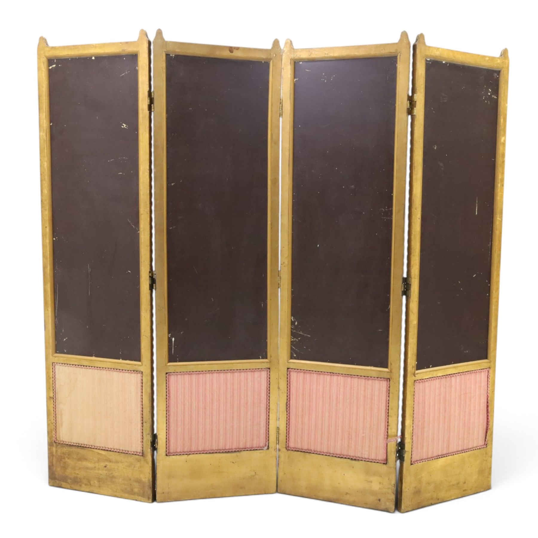 Early 20th century gilt and bevelled mirrored four panel folding screen, with two mirrors per side, flanked by beaded edges and scrolled finials, arcaded carved frieze