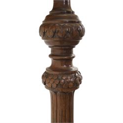 Late 19th Century mahogany standard lamp with shade, canvas beige shade, above a carved and turned column, on a carved base with pad feet