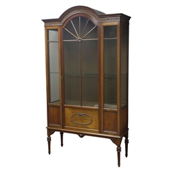  Edwardian mahogany display cabinet, stepped arch top with fluted frieze carved with flower heads, astragal glazed and panelled door with mounted ribbon tie wreath, turned lobed and fluted supports, W106cm, H190cm, D39cm  