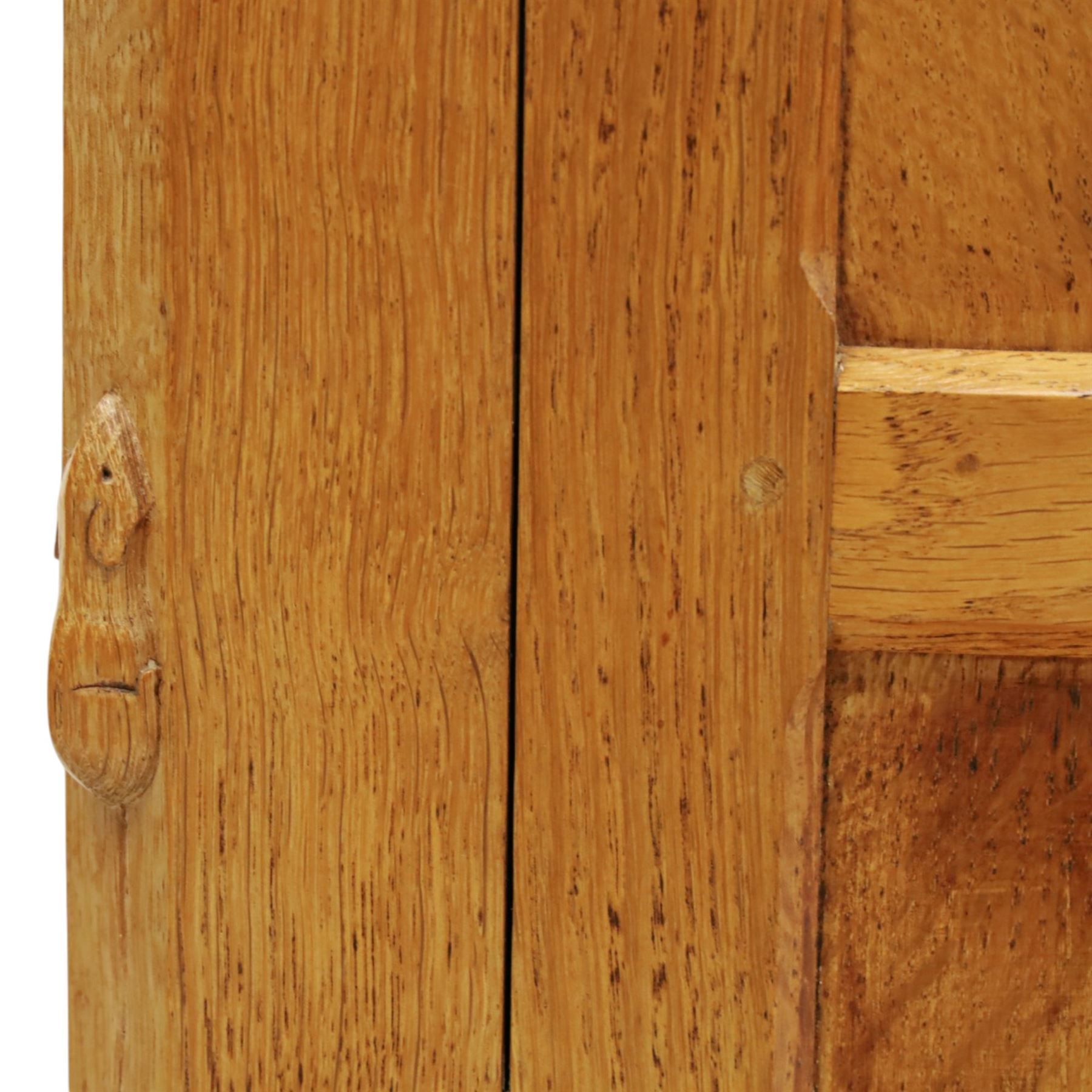Mouseman - large adzed light oak sideboard, the rectangular top with raised galleried back, fitted with three central drawers flanked by panelled cupboards enclosing shelves, with wrought iron fittings, raised on octagonal feet, with signature carved mouse, by the workshop of Robert Thompson, Kilburn