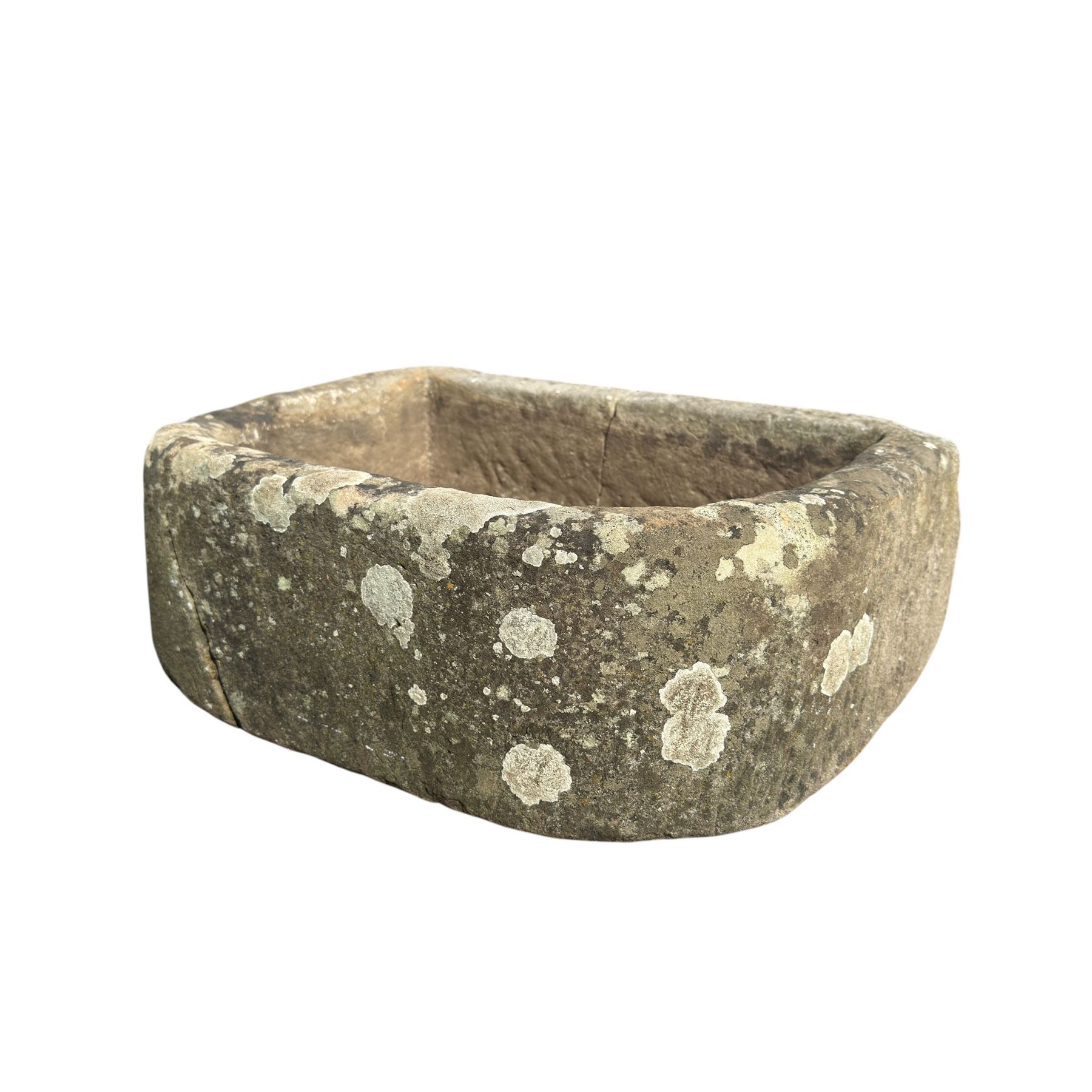 19th century hewn sandstone trough of D shaped form, in weathered finish