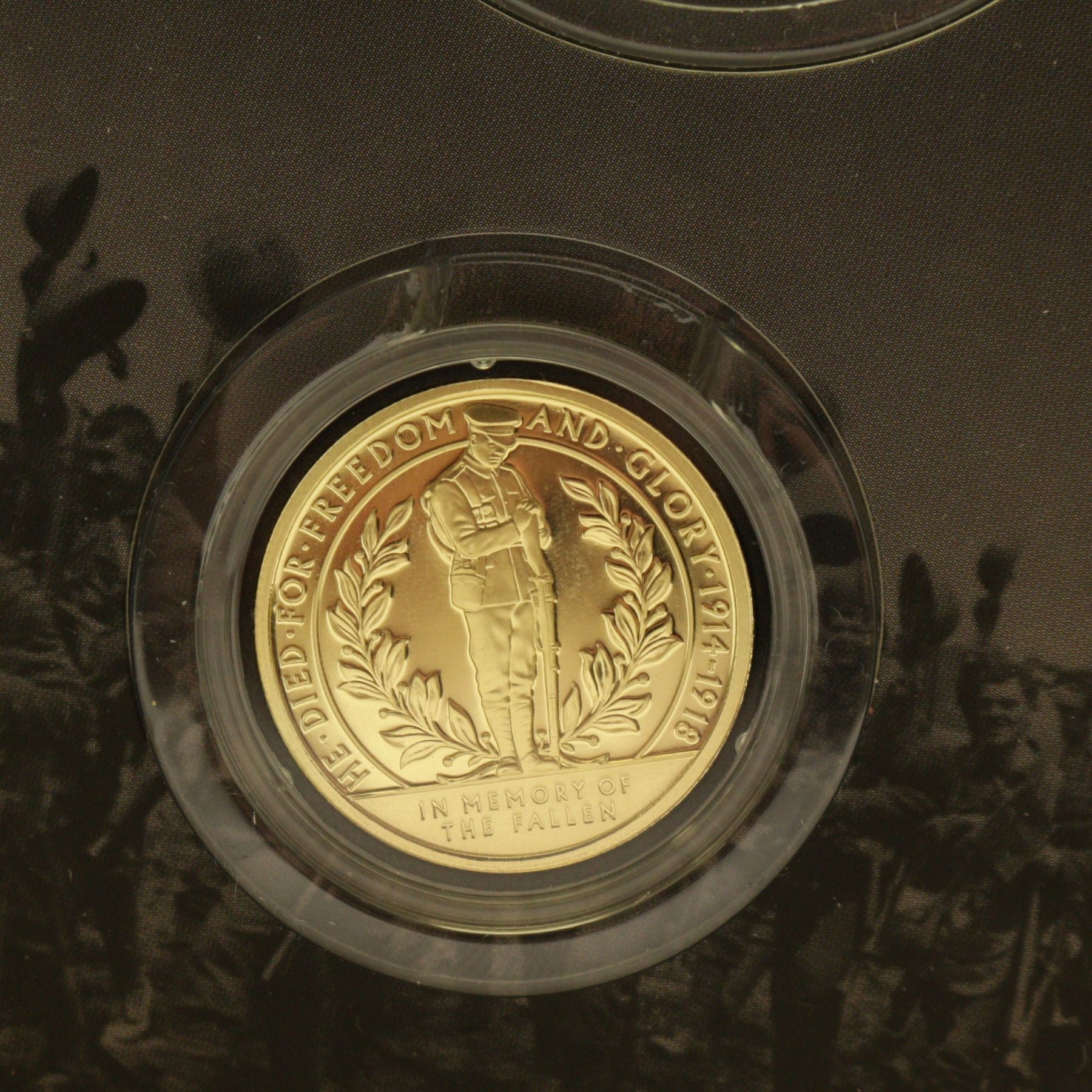 The London Mint Office 'A War To End All Wars', part coin set including Queen Elizabeth II Gibraltar 2017 9 carat gold 10 grams double crown coin etc, in card folder