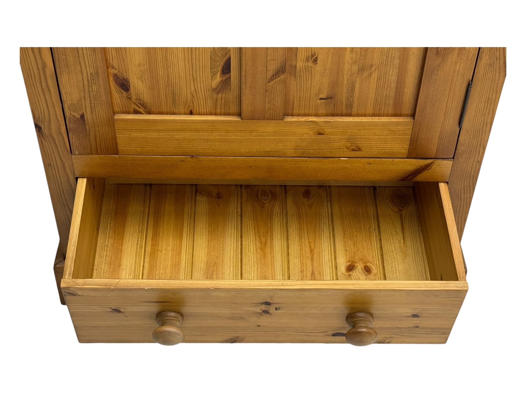 Pine single wardrobe, enclosed by single panelled door, fitted with single drawer, on plinth base 