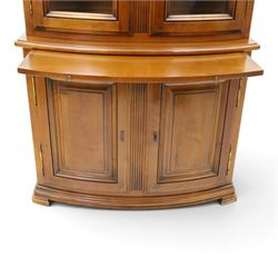 Wesley Barrell - French cherry wood bow front display cabinet, the upper section with glazed doors and three adjustable shelves, raised on cupboard base with brushing slide and further adjustable shelf, raised on a moulded plinth base with bracket feet