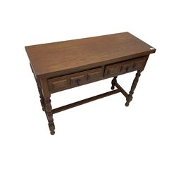 Spanish oak side table, fitted with two drawers with moulded facias, raised on turned supports united by stretcher