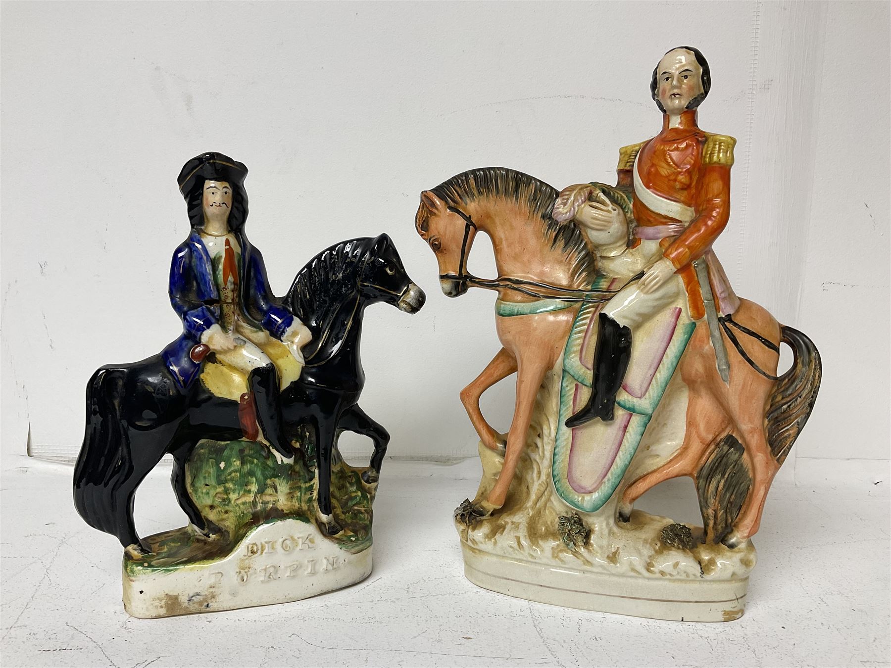 Staffordshire figure of the Duke of Wellington on a bay horse, H30cm in red uniform, together with a similar Staffordshire figure of Dick Turpin, pair of Staffordshire style dogs, H27cm, three Meissen style double salts and two trinket boxes 