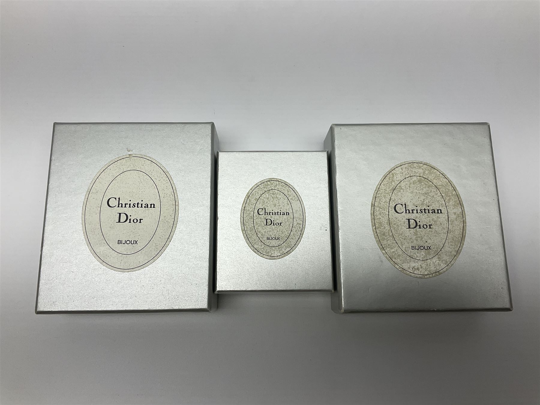 Christian Dior costume jewellery, comprising pair of pearlescent clip on earrings, enamel and paste leaf brooch and a pierced stylised leaf brooch, each stamped Chr.Dior Germany and in original boxes