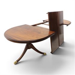 Regency design mahogany extending twin pedestal dining table with two additional leaves, raised on splayed supports terminating brass paw feet
Extends to 268cm