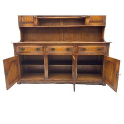 Traditional oak dresser, raised plate rack fitted with two cupboard, the dresser with moulded rectangular top over three drawers and three cupboards, stepped arch panelled doors