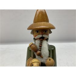 German Erzgebirgische Volkskunst folk art carved and stained wood smoking men incense burner figure, modelled smoking a pipe, with sticker label beneath, H19cm
