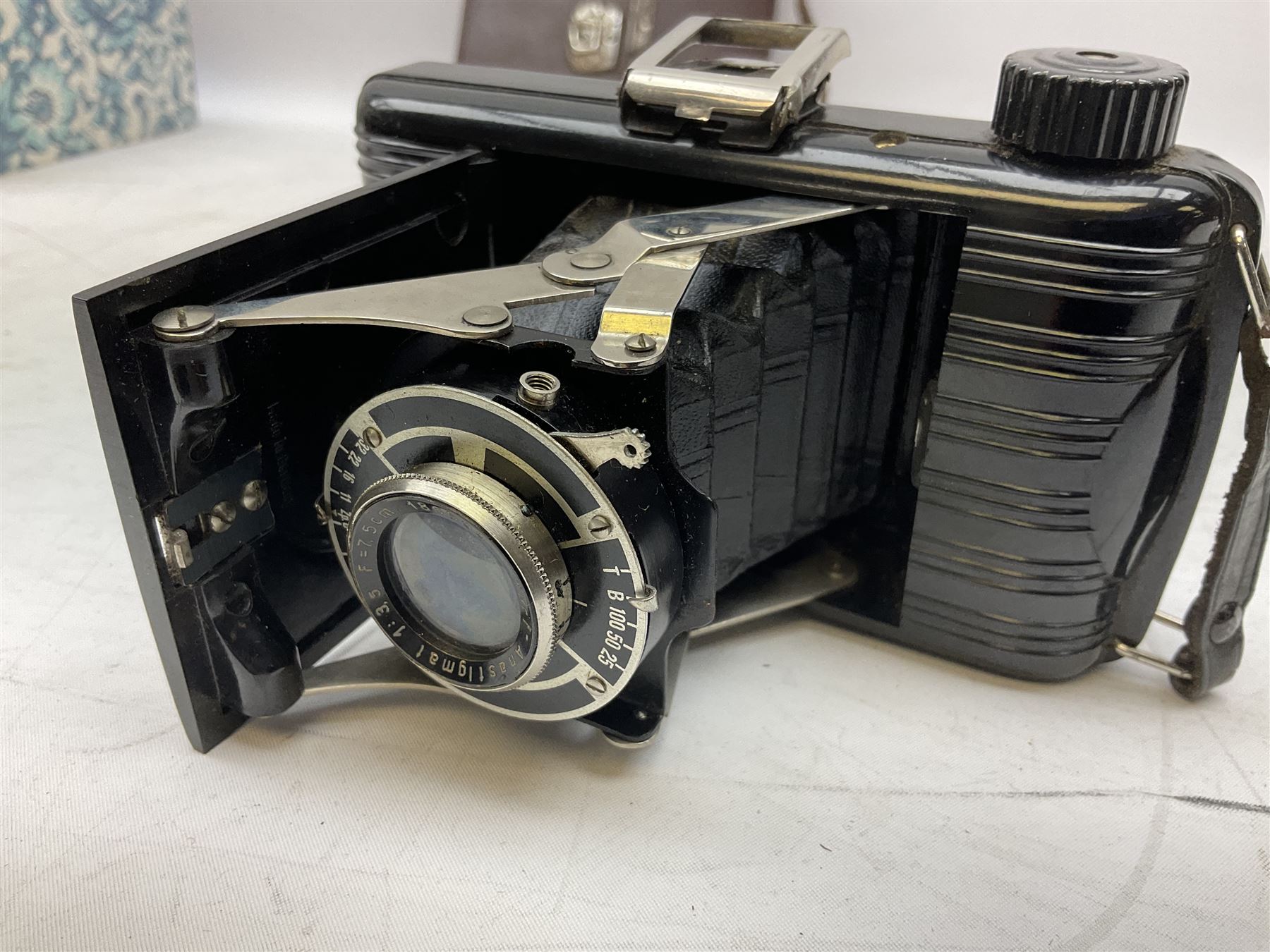 Bilora Boy Box Camera, with leather case, together with Zeiss Ikonta folding camera and another similar example 