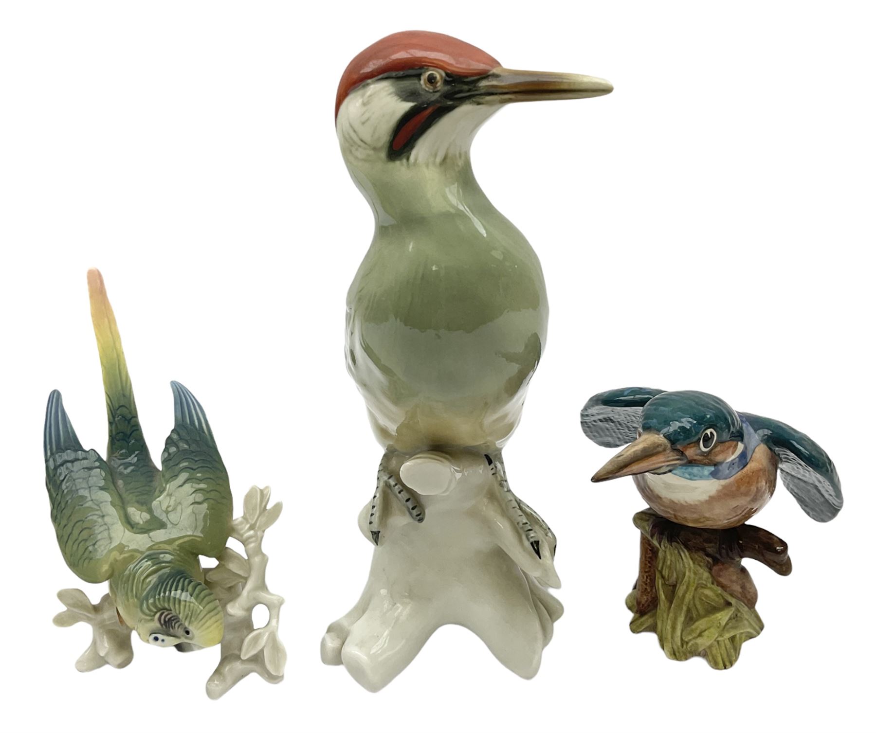 Karl Ens figure of a green woodpecker, modelled perched upon branch, model no. 7527, together with Karl Ens figure of budgie and Beswick Kingfisher no. 2371, all with printed marks beneath, tallest H25cm