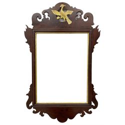 Early 19th century Chippendale design mahogany framed wall mirror, the pierced and foliate carved pediment with a central gilt Ho Ho bird motif, the rectangular plate within a gilt slip, shaped and carved terminal
