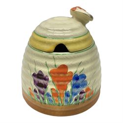 Clarice Cliff for Newport Pottery honey pot, modelled as a beehive and painted in the Crocus pattern, the lift off lid with bee finial, with green printed mark beneath, H9.5cm