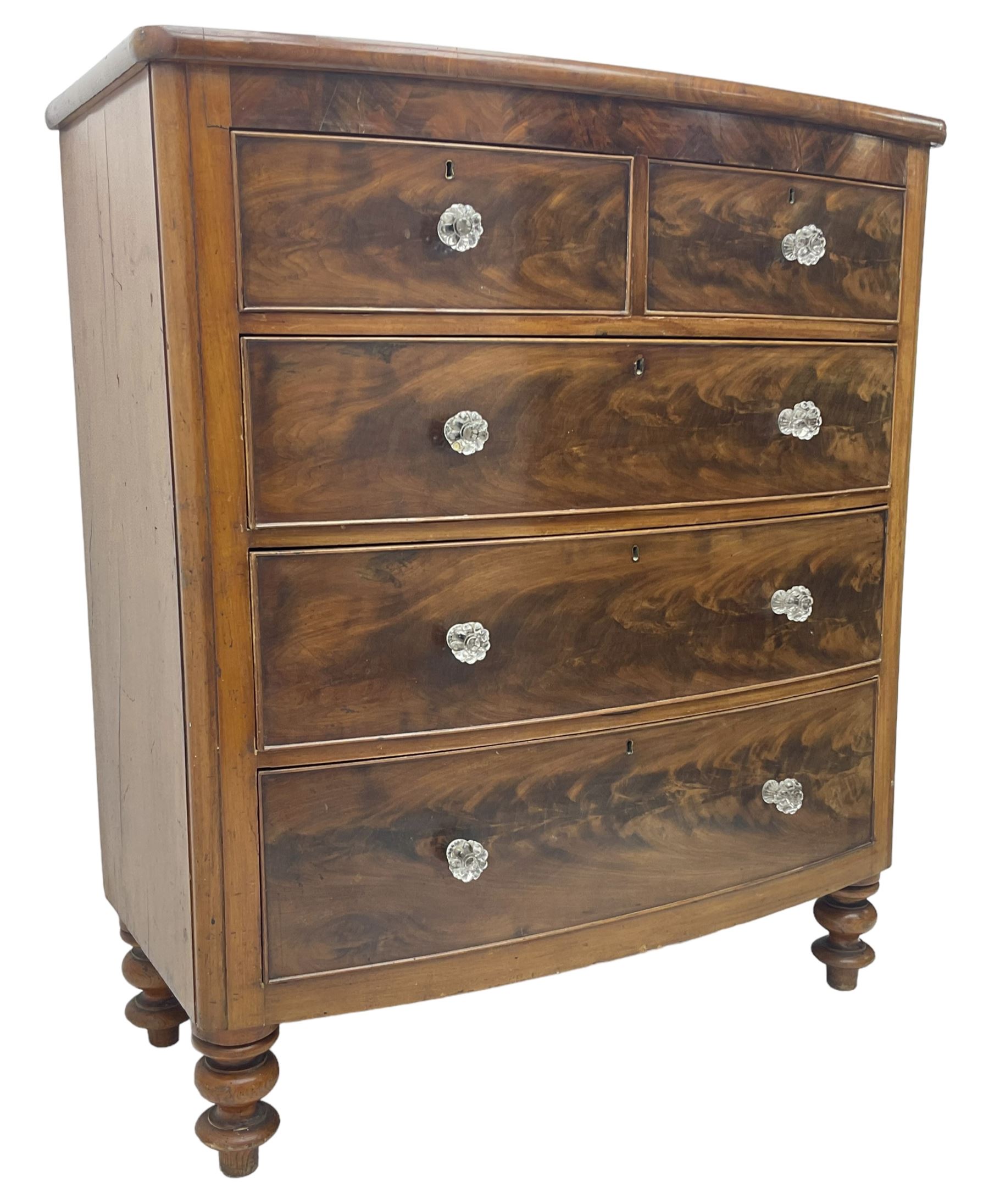 Victorian mahogany bow front chest, fitted with two short over three long graduating cock-beaded drawers, each with glass handles, raised on turned feet