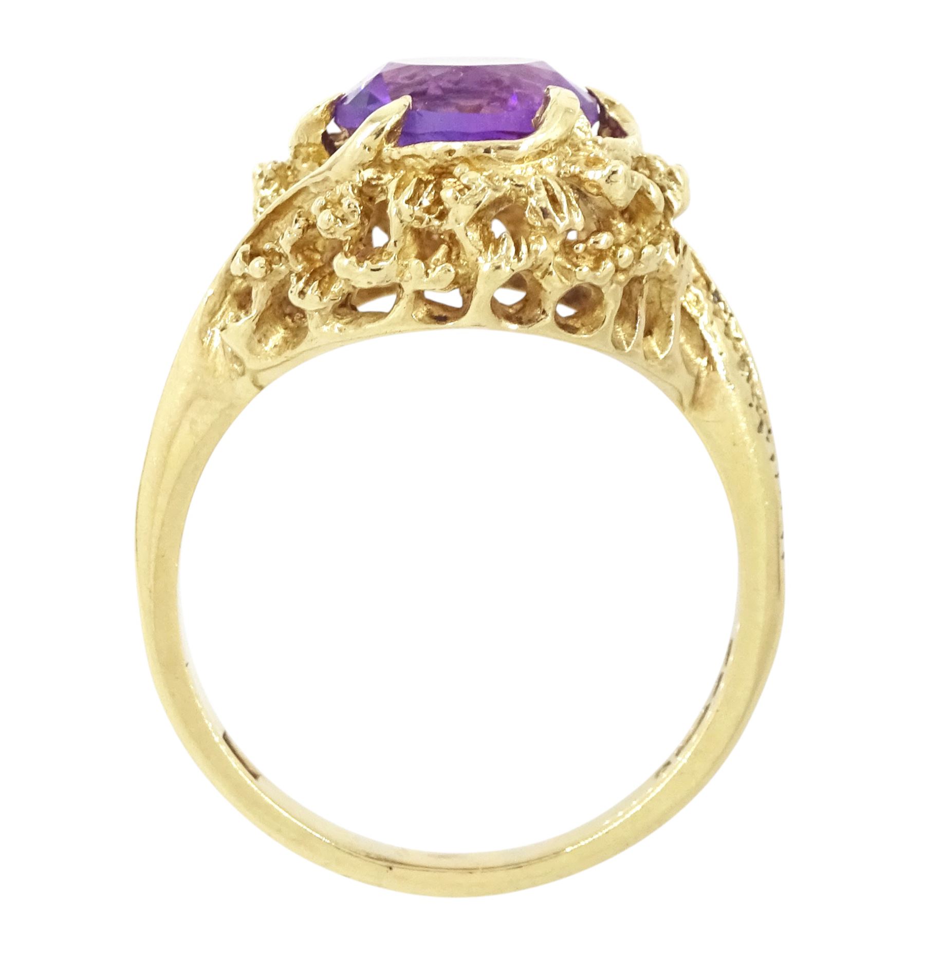 9ct gold amethyst single stone ring, round cut amethyst set within a pierced textured surround, London 1972