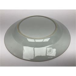 Three 18th century Chinese Famille Rose plates, the first example enamelled with blossoming peonies, rockwork and fence, the other two examples of similar design, decorated with blossoming peonies and sprigs within shaped inner borders, each approximately D23cm