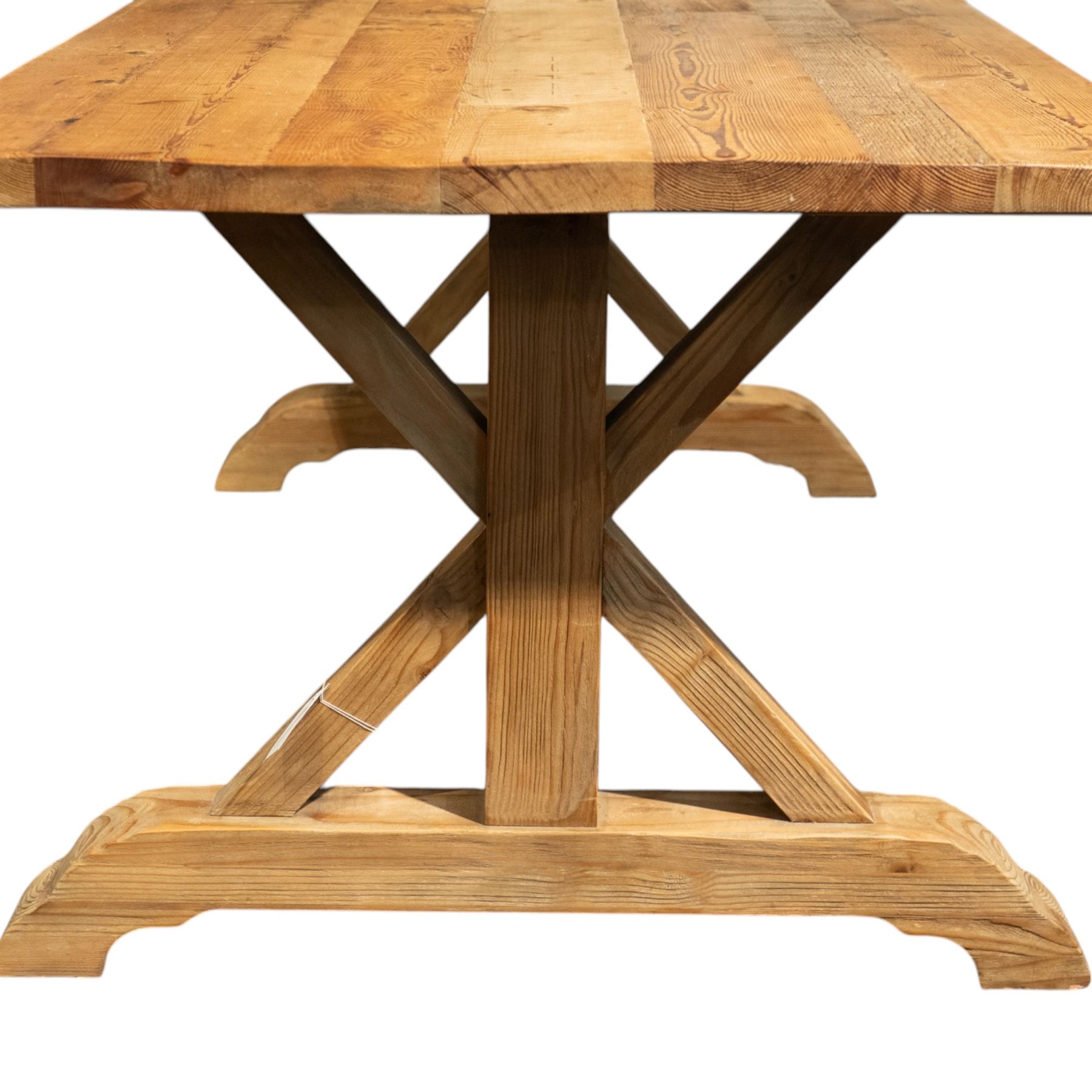 Pine country x-framed dining table, a rustic plank top raised on two x-framed supports