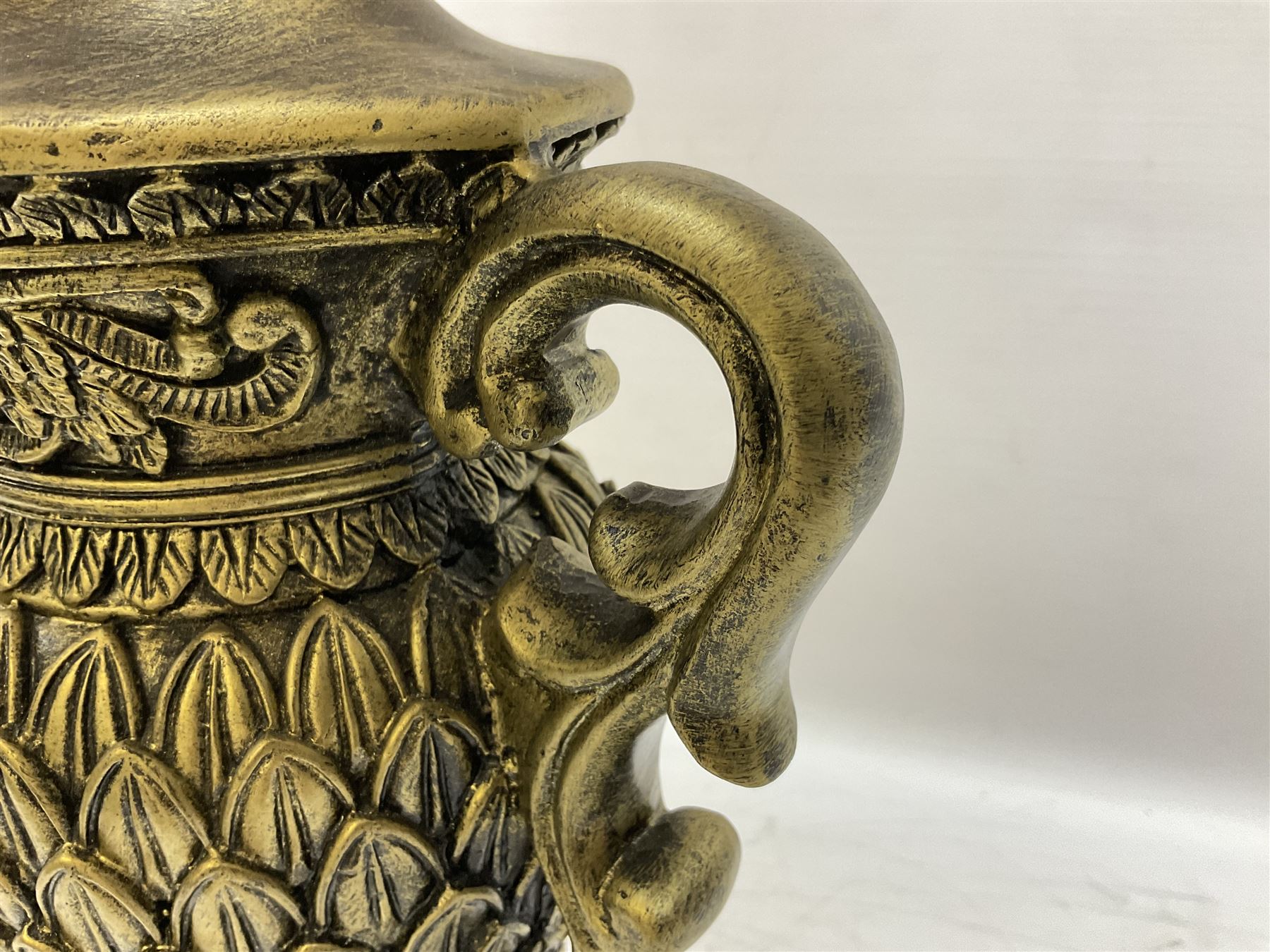 Pair bronzed amphora lamps with pineapple decoration, scroll handles and foliate base with scrolled feet together with pair peach ground shades and raised floral pattern H76cm (2)