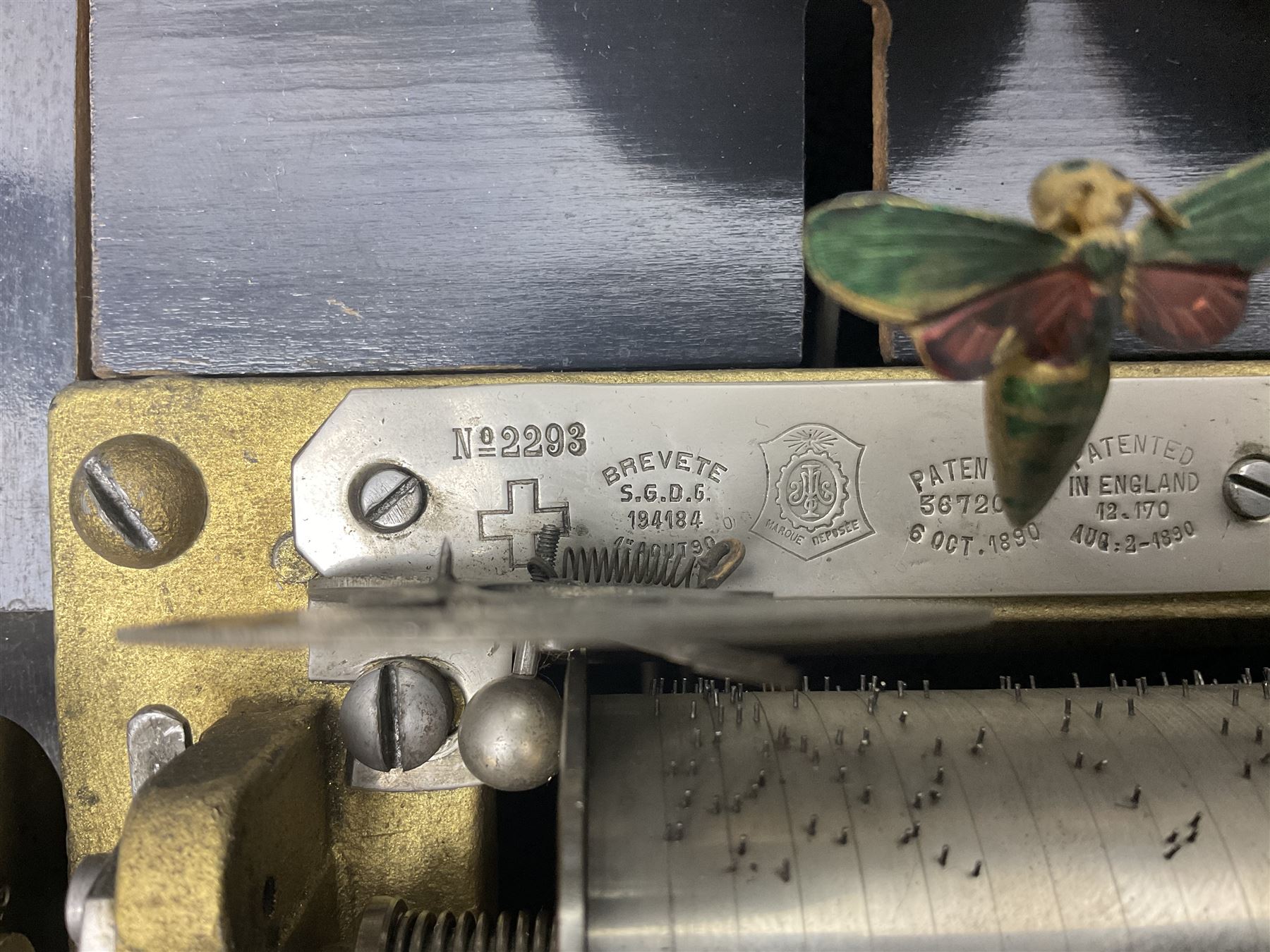 Swiss - 19th-century cylinder music box with three butterfly bells in sight, in a mahogany case with two separately boxed  6” cylinders, glazed viewing lid, 41 tooth comb (one tooth broken) crank key missing, movement untested.