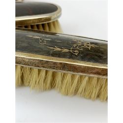 A silver mounted faux tortoiseshell dressing table set, comprising hand held mirror, two hair brushes, and two clothes brushes, each with inlaid swag to the back, hallmarked Lionel Smith & Co, Birmingham 1927, plus a silver mounted clothes brush with engine turned decoration and monogramed plaque, hallmarked William Neale & Son Ltd, Birmingham 1929, pair of silver plate on copper bottle coasters, cased set of fish servers, and cased set of fish eaters and servers, the knife blades marked Mappin & Webb. 