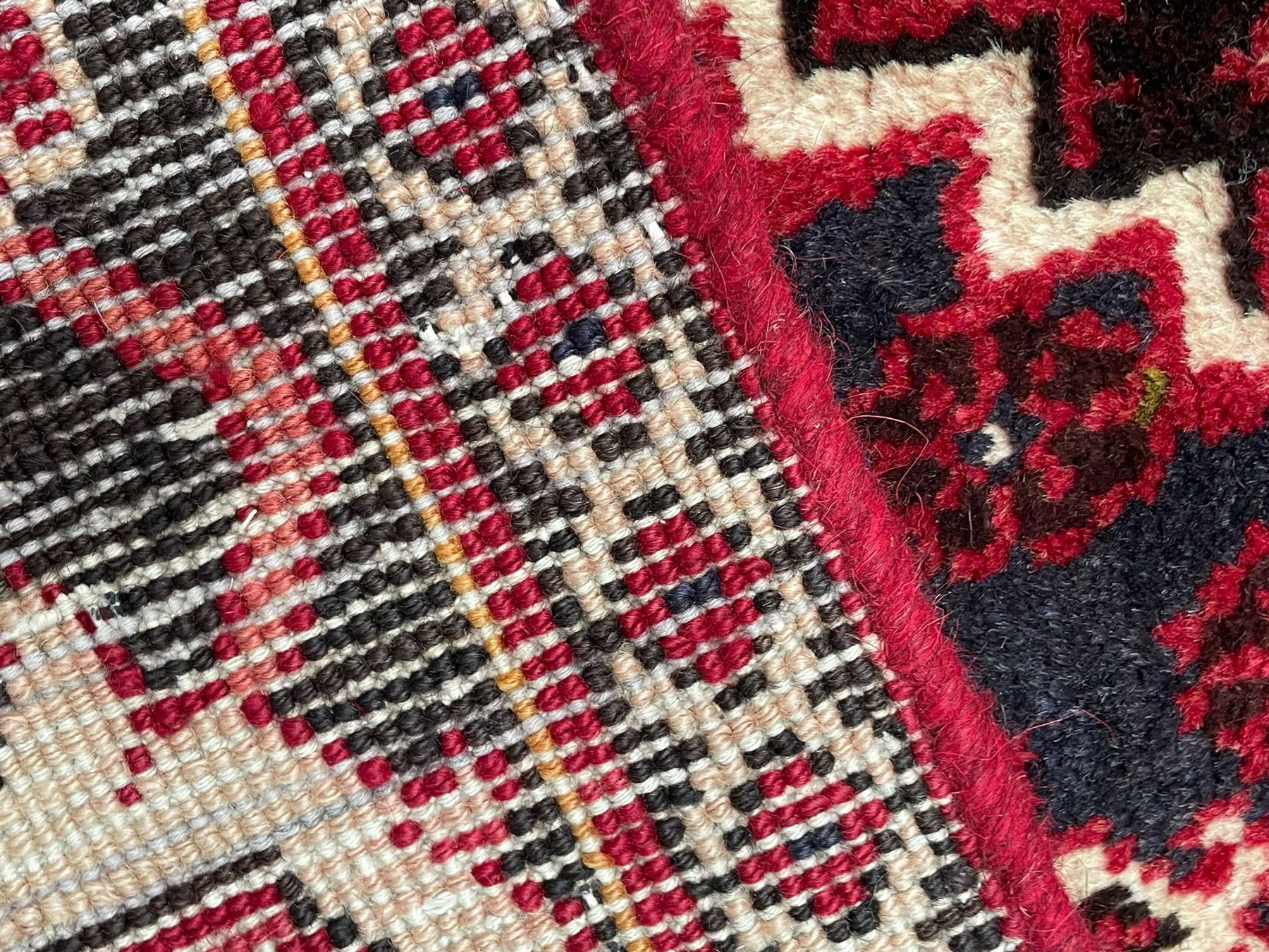Persian Joshaghan crimson ground rug, stepped lozenge medallion surrounded by repeating foliate lozenge motifs, the border decorated with stylised plant motifs, within geometric guard stripes 