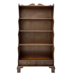Late 20th century mahogany waterfall bookcase, fitted with two drawers, on bracket feet