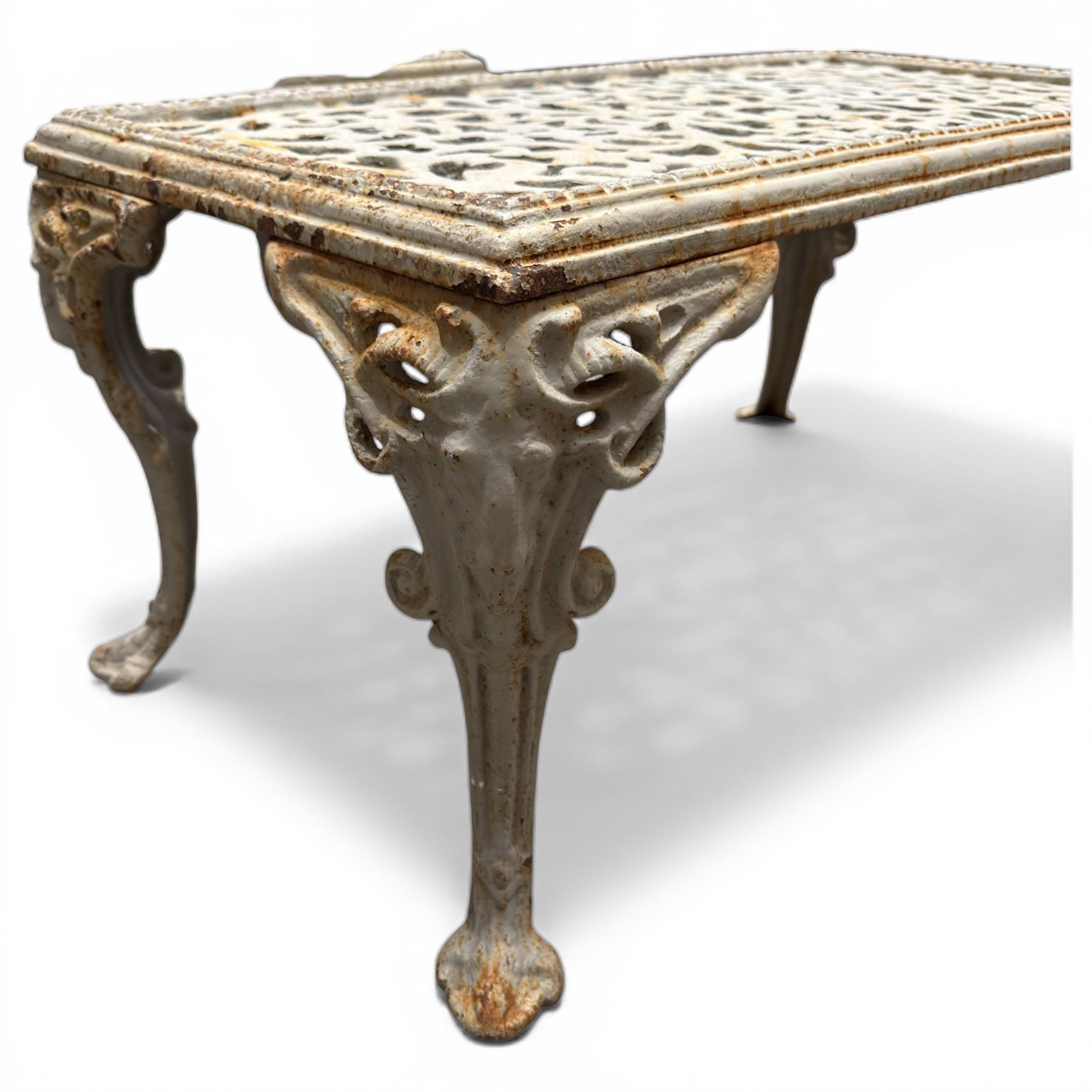 Pair of cast iron low garden tables with rams head legs in a white finish