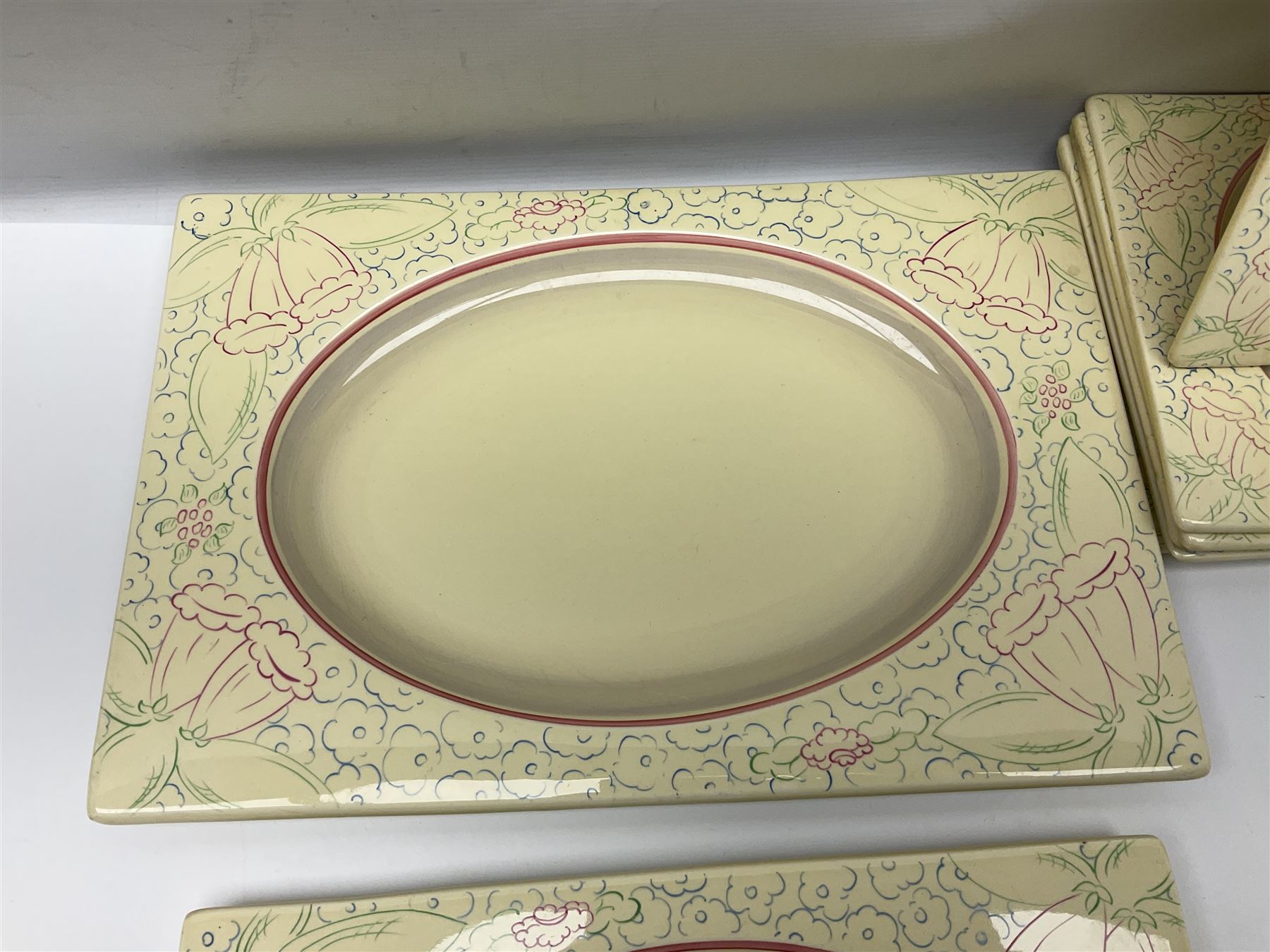 Clarice Cliff Biarritz part dinner set, circa 1930, for Royal Staffordshire, of rectangular form, decorated with bluebells, to include one serving plate, six dinner plates, three side plates, etc, printed mark beneath with reg no 784849 (17)