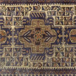 Baluchi design wool rug, with three geometric medallions on a cream field, enclosed by multiple dark blue, brown and rust geometric borders with fringed ends