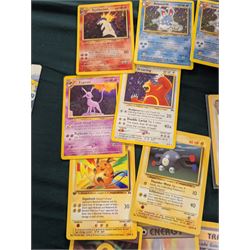 Collection of Pokemon TGC trading cards, including two WB First Movie Black Star promo cards Pikachu no. 4 and Dragonite no. 5, two Ancient Mew Black Star holo promo cards, Gym Challenge Giovanni's Persian 8/132 holo and a small collection WOTC, Neo Discovery and Neo Genesis cards, together with thirty four Bandai Carddass Pokemon cards, including prism Charizard no. 186 and Pokemon Topps cards including holo examples 
