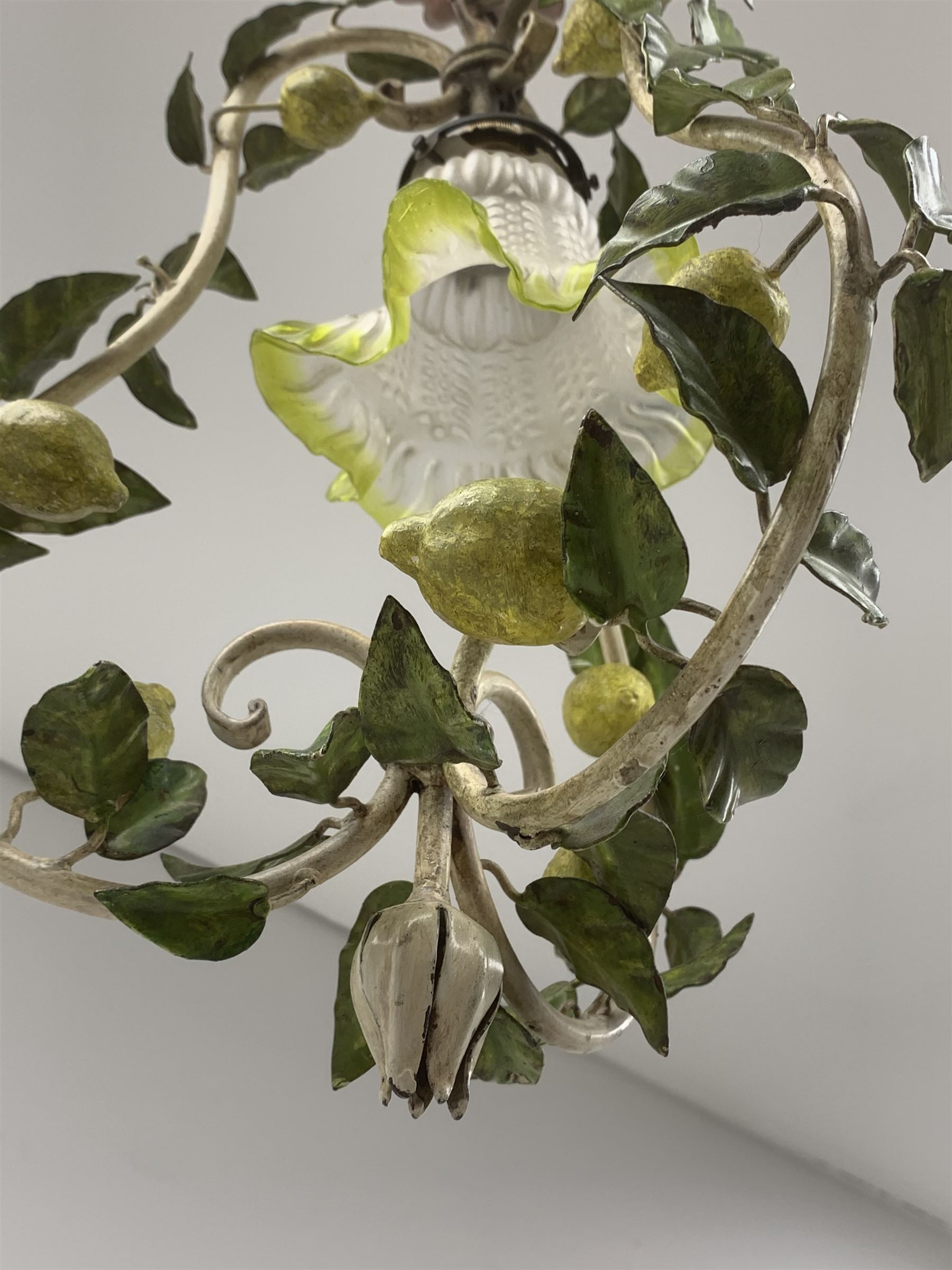 A toleware light fitting modelled with fruiting lemon vines around a frilled glass shade, approximately H48cm